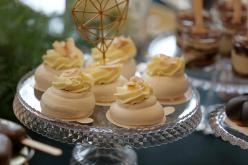Meringue cupcake with cream on a catering table