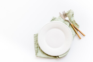 Dinner plate setting with cutlery and napkin. Top view