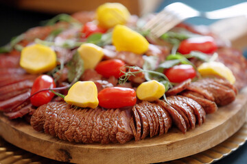 Fresh dry smoked homemade sausage on catering table