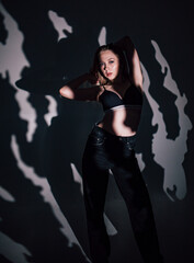 beautiful girl in a black bodice in the studio, chiaroscuro on her face