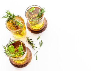 Fresh summer cocktail with cold tea and rosemary in glasses