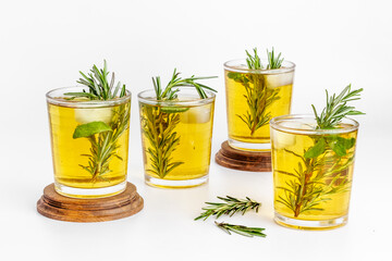 Fefreshing drink of cold tea and rosemary herbs in glasses