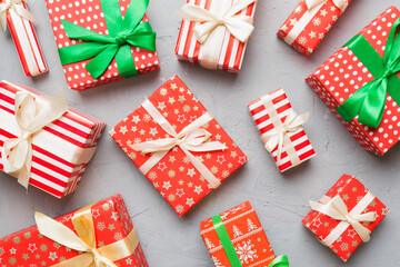 A lot of Christmas gift boxes in colored paper decorated on table, Top view close up. Many present New Year gift