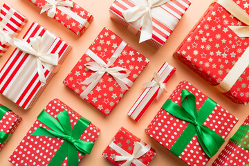 Obraz premium A lot of Christmas gift boxes in colored paper decorated on table, Top view close up. Many present New Year gift