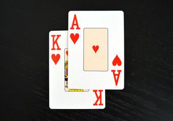 Blackjack Cards and Gambling - Lucky hand showing an ace of Hearts and King, symbol of luck and money
