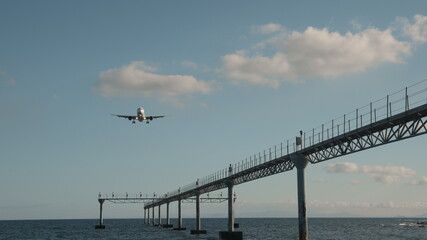 A plane flying low over the deep blue sea