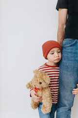 Caucasian little boy, hugging his father at home, isolated image, copy space. Family concept