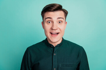 Portrait of excited crazy guy palm ear eavesdropping close look camera omg reaction on turquoise...