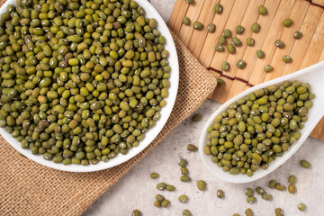 Raw mung bean on wooden table background.