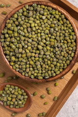 Raw mung bean on wooden table background.