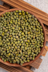 Raw mung bean on wooden table background.