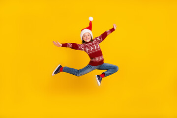 Full body photo of cheerful little happy girl jump up christmas sale isolated on yellow color...