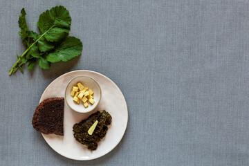 Fried turnip leaves with ginger. Vegetable greens cooking. Flat lay, top view.