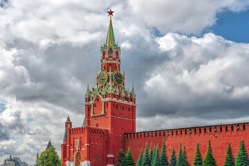 City landscape, Centre of Moscow, view at Spasskaya tower of Moscow Kremlin and wall on Red Square. Clouds sky background.