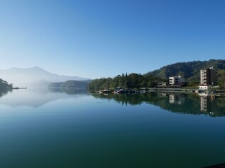 Fototapeta na wymiar A perfect morning reflection of a calm Sun Moon Lake, Taiwan