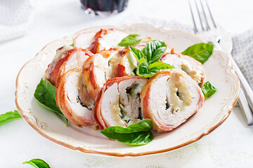 Baked chicken rolls with basil and cheese on  plate. Healthy lunch. Keto diet.