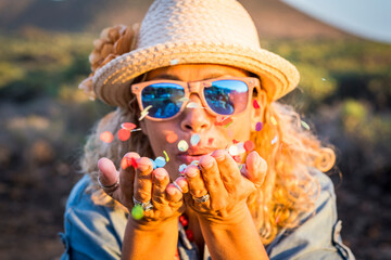 Happiness and celebration outdoor activity with cheerfual joy adult young woman blowing colorful...