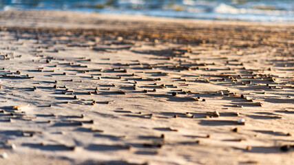 The shadows of stones on the beach.
