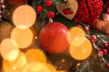 Fototapeta na wymiar Christmas background with tree and balls, garland in defocus. New year card and copy space.