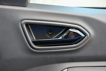 Black interior door handle in a budget vehicle