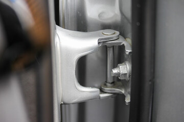Close up of a car door hinge - obrazy, fototapety, plakaty