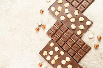 Assortment of Milk chocolate bar with whole hazelnut kernels on white background. Healthy food concept, delicious chocolate sweets for kids, diet, sugar