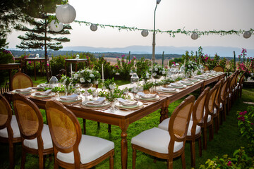 Wedding organization preparation restaurant and wedding planners.Chairs and honeymooners table decorated with candles, served with cutlery and crockery and covered with a table cloth. wedding area