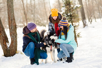 Fototapeta na wymiar Full body photo of cheerful family happy positive smile walk park pet dog husky weekend vacation snowy