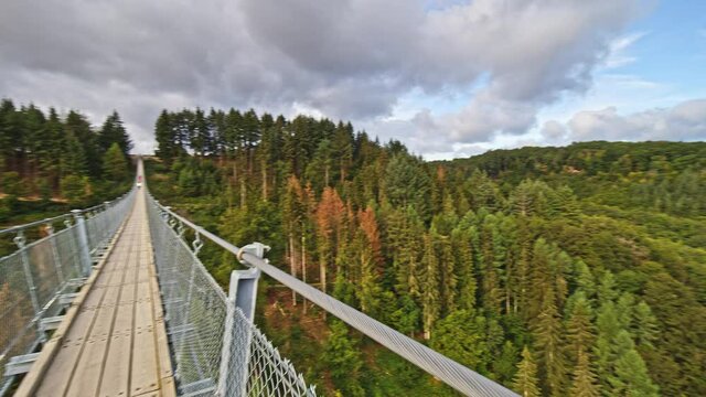 Slow motion, point of view shot of a person walking on Geierlay suspension bridge near Moersdorf and Sosberg, Germany.