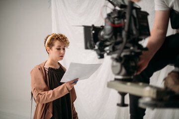Director at work on the set. Shooting shift, equipment and group. Modern photography technique.