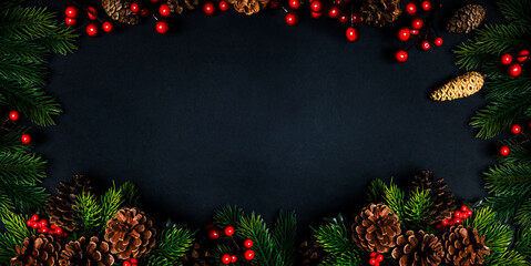 Christmas frame with holiday garland on black background. Top view. Traditional new year eve...