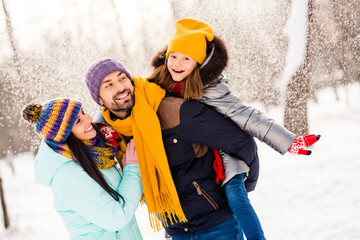 Photo of lovely family happy positive smile enjoy time together walk snowy park winter frost have fun piggyback