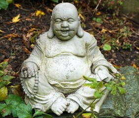Fototapeta na wymiar Laughing Buddha statue sitting in the garden