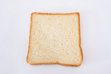 one white slice of bread on a white plate.