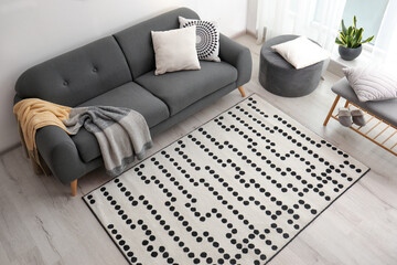 Living room interior with comfortable sofa and stylish rug, above view - obrazy, fototapety, plakaty