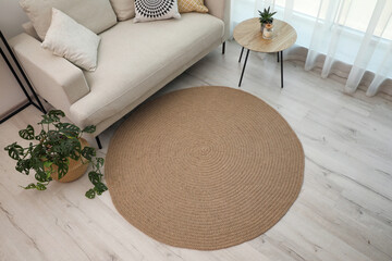 Living room interior with comfortable sofa and stylish round rug, above view