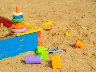 Fototapeta na wymiar Bright children’s sandbox with colorful toys