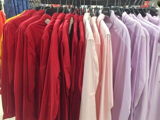 Different colored shirts that hung neatly.