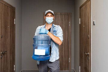 Fototapeta na wymiar Delivery water man wear protective face medical mask during coronavirus pandemia