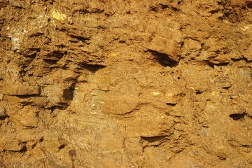 Rough clay soil with uneven grit, stones and texture natural horizontal backdrop