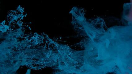 Blue watercolor paints in water on a black background. Awesome abstract background. Beautiful wallpaper for your desktop. Blue cloud of ink on a black background.