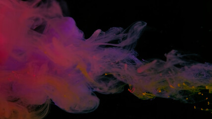 Scarlet, yellow, purple and orange watercolor paints in water on a black background. Awesome abstract background. Beautiful wallpaper for your desktop. Colored cloud of ink on a black background.