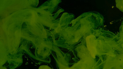 Beautiful wallpaper for your desktop. Green cloud of ink. Awesome abstract background. Drops of green ink in water. Cosmic star background.