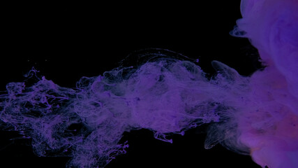 Violet cloud of ink on a black background. Drops of purple ink in water. Purple watercolor paints in water on a black background. Awesome abstract background.