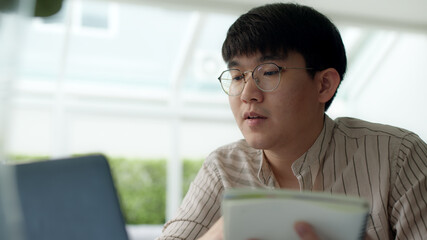 Asia people glasses chinese male busy talk discuss on desk at home in employee digital reskill...