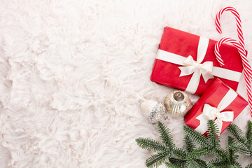 Christmas composition. Gift box, christmas decorations on wool background. Flat lay, top view, copy space.