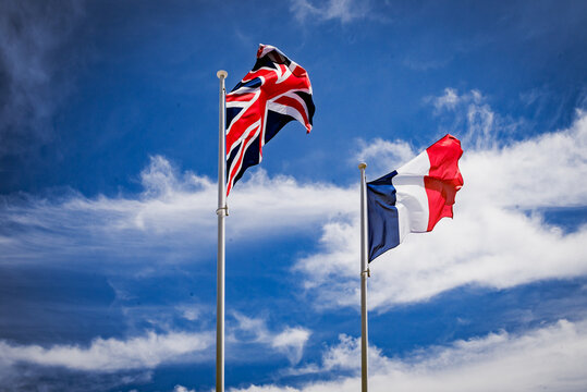 British Union Jack and French Flags with sky