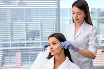 healthcare, medical and surgery concept. cosmetologist or doctor with patient, preparing to do injection, Thread Lifting, PDO thread. Aesthetic beauty anti aging, face lifting surgery. copy space
