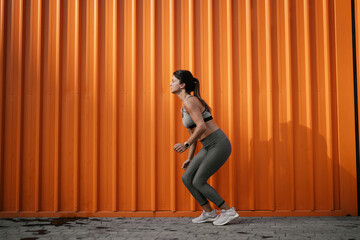 Beautiful athlete woman in sportswear. Young woman training outdoors.