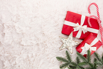 Christmas composition. Gift box, christmas decorations on wool background. Flat lay, top view, copy space.